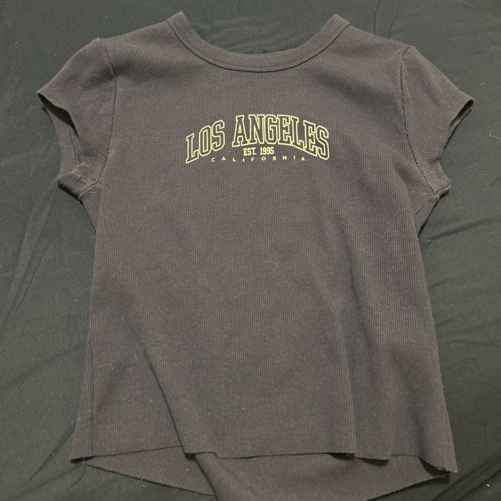 This tee has been lightly worn - super cute raw hem